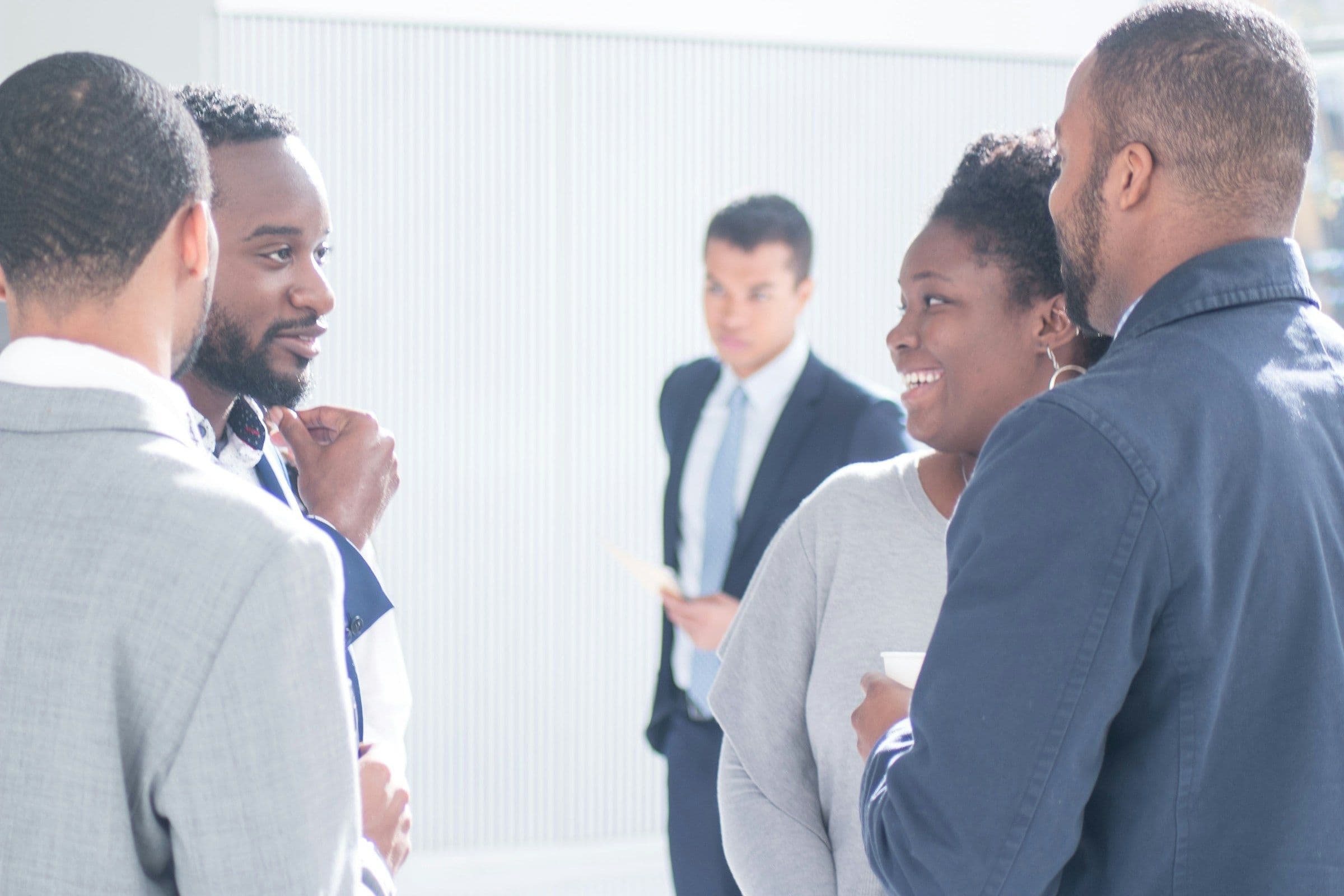 Real estate professionals talking at a networking event